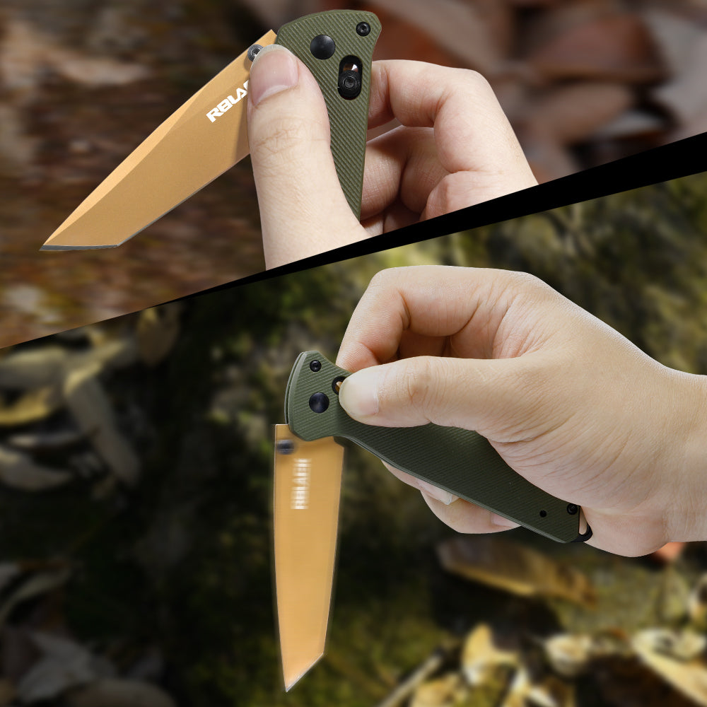 Close-up of a hand holding a folding knife with a green handle and orange blade, against a natural background. RBLACK crossbar lock detail on blue G10 tanto folding knife